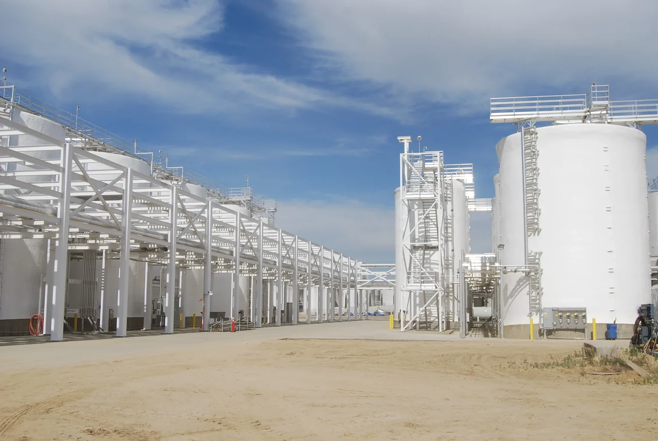 White-coated tank farm and pipe rack at an industrial facility