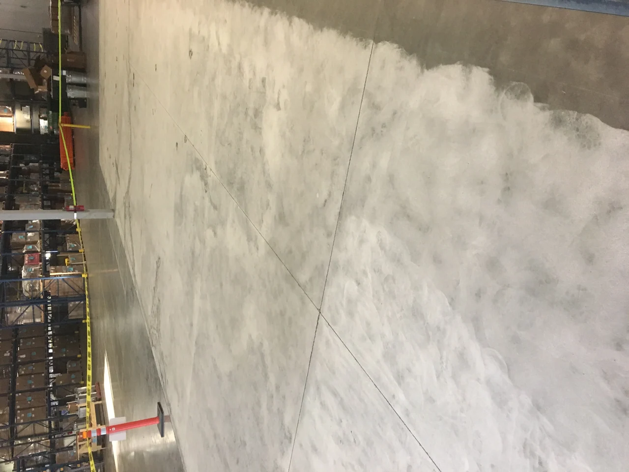 Concrete floor surface preparation inside a warehouse