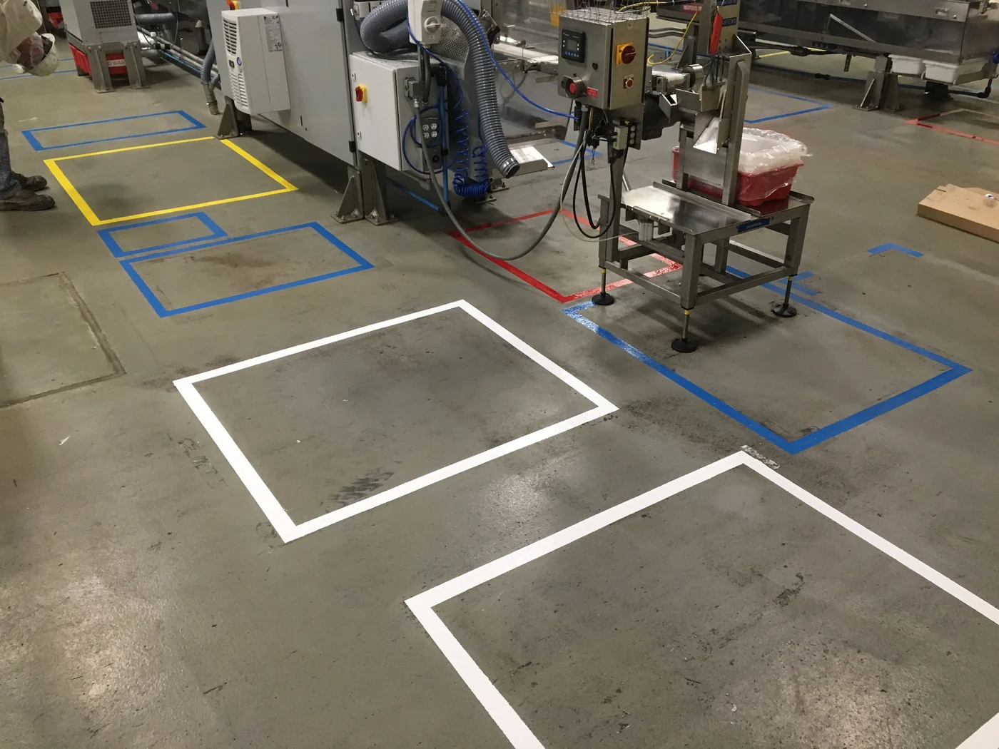 Yellow safety zone striping on a production floor