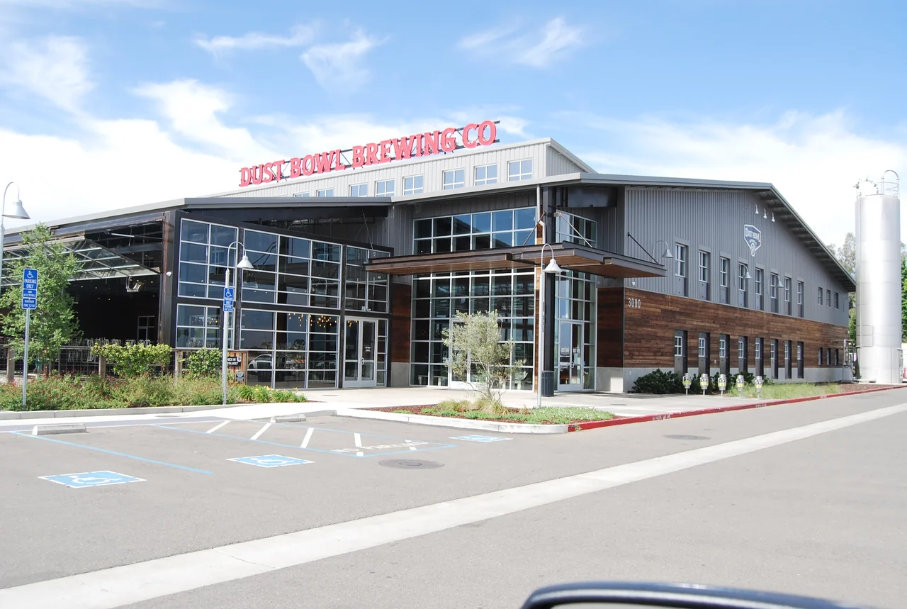Repainted brewery building exterior with glass entry and metal cladding