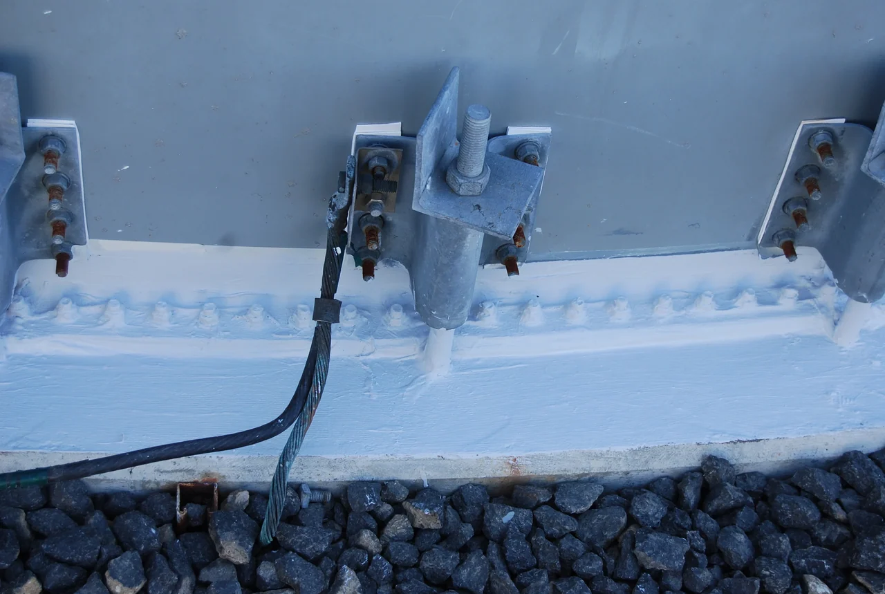 Close-up of protective coating around tank base fittings
